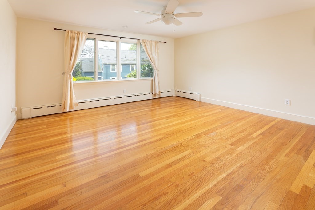 39 Cedarwood Road Boston, MA 02130 - Photo 7 of 11 an empty room with wooden floor and windows