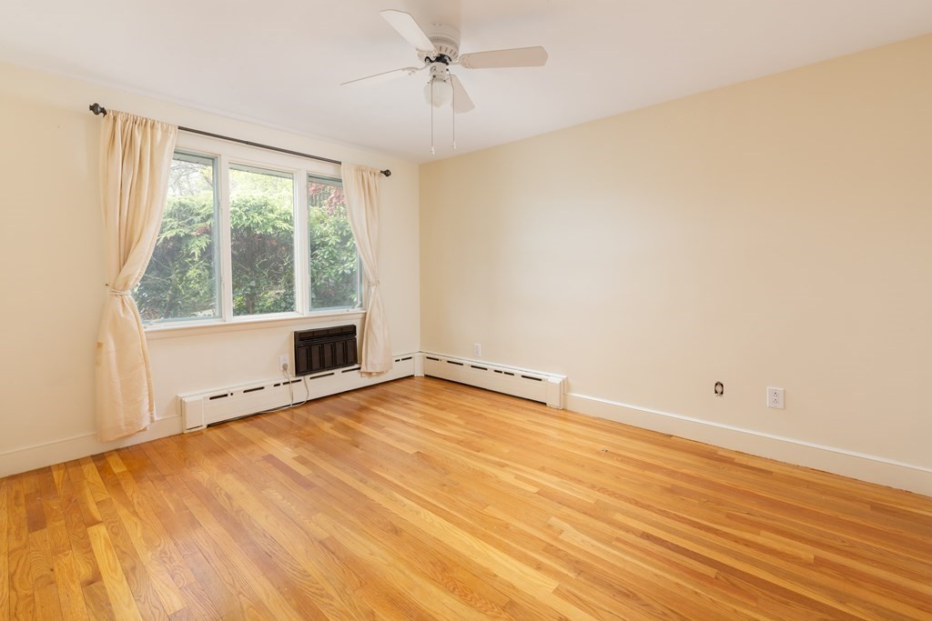 39 Cedarwood Road Boston, MA 02130 - Photo 8 of 11 wooden floor in an empty room with a window