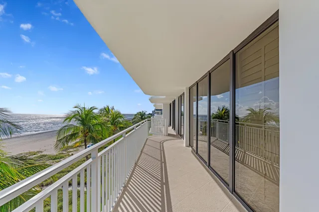 a view of balcony with floor to ceiling window and wooden floor