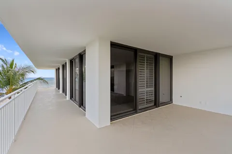 a view of a hallway with wooden floor and entryway
