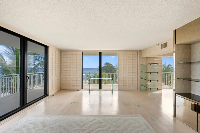 a view of a living room hardwood floor and a window