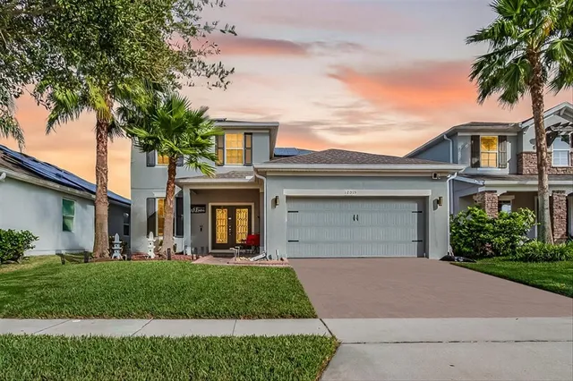 a front view of a house with a garden and plants