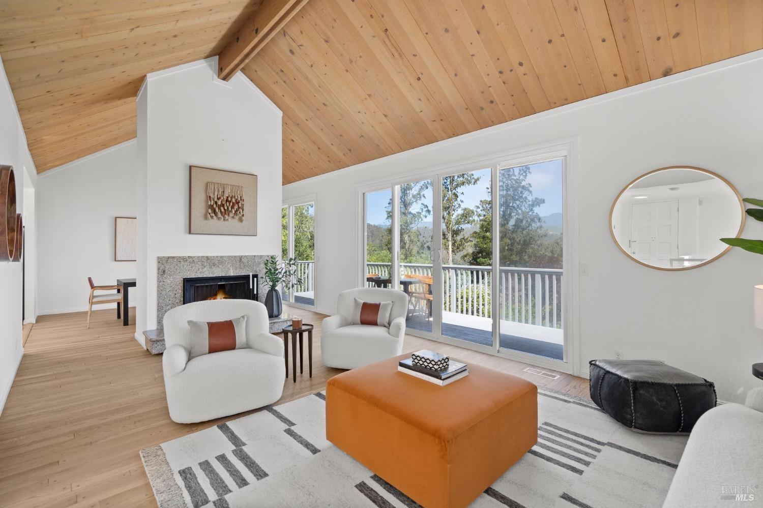 881 Marin Drive Mill Valley, CA 94941 - Photo 1 of 1 a living room with furniture a large window and a fireplace