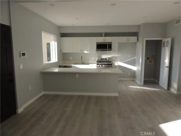 an empty room with windows and closet