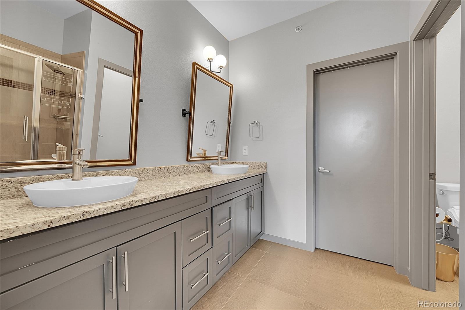 4158 Longview Lane Boulder, CO 80301 - Photo 13 of 15 a bathroom with a granite countertop double vanity sink and a mirror