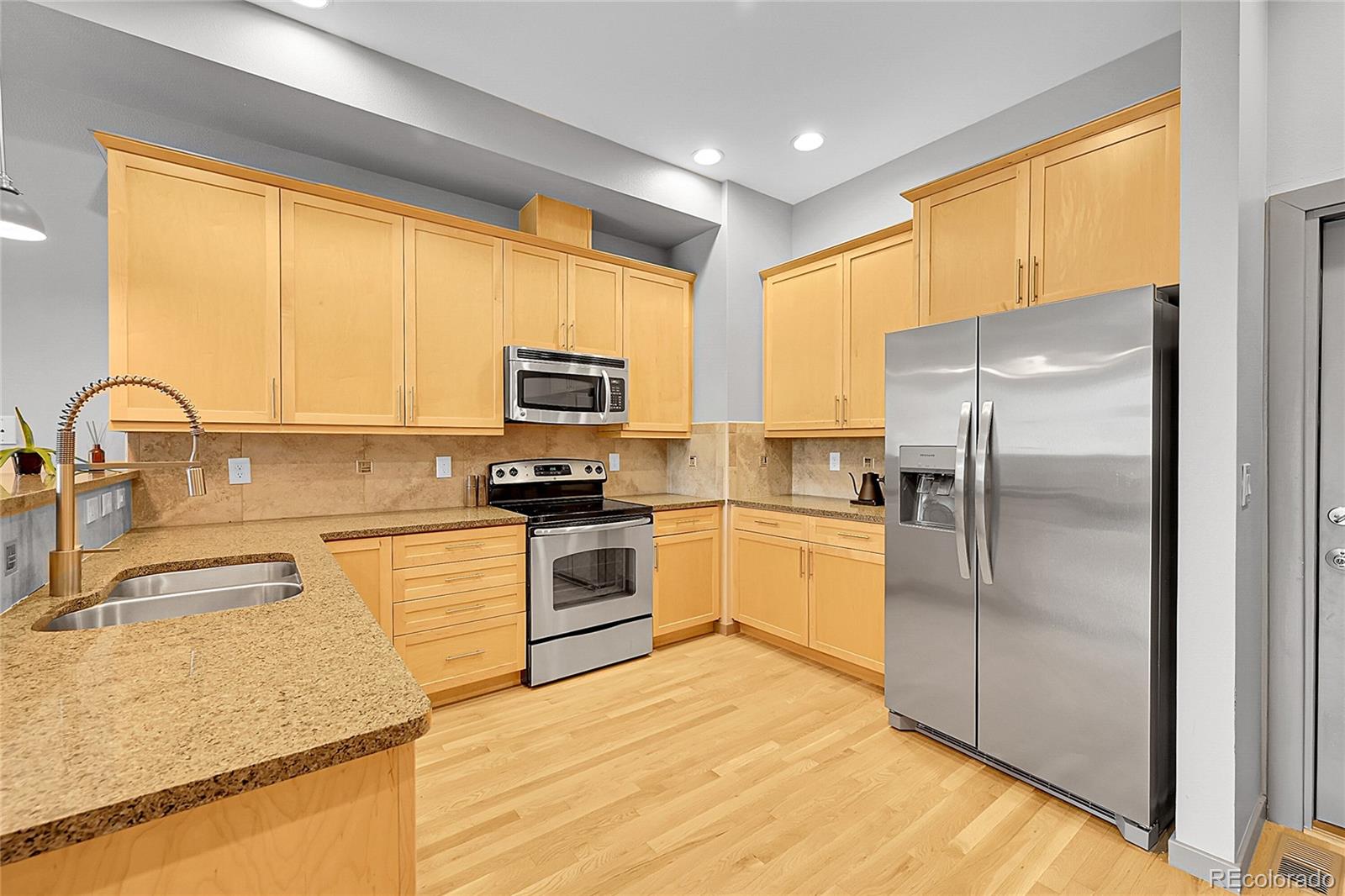 4158 Longview Lane Boulder, CO 80301 - Photo 5 of 15 a kitchen with kitchen island granite countertop a sink appliances cabinets and counter space