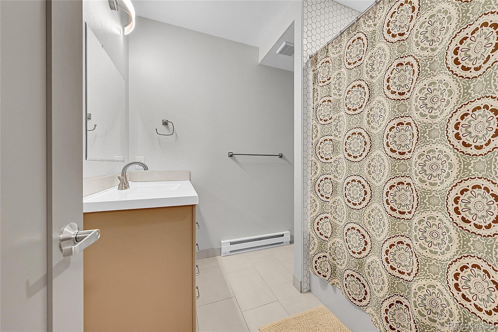 4158 Longview Lane Boulder, CO 80301 - Photo 7 of 15 a bathroom with a sink and mirror with shower curtain