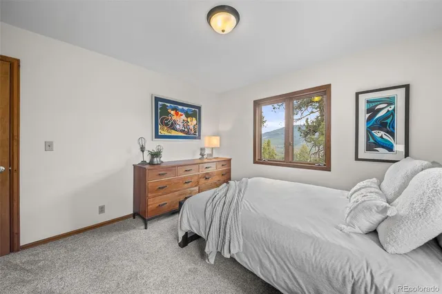 a bedroom with a bed and a dresser next to it