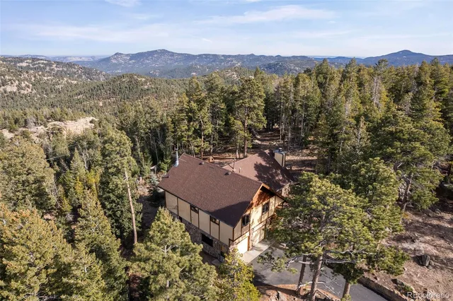 an aerial view of a house with a yard