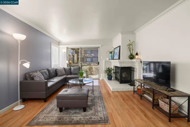 a view of a house with a small yard and wooden floor