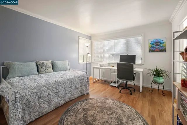 a living room with furniture and a flat screen tv with wooden floor