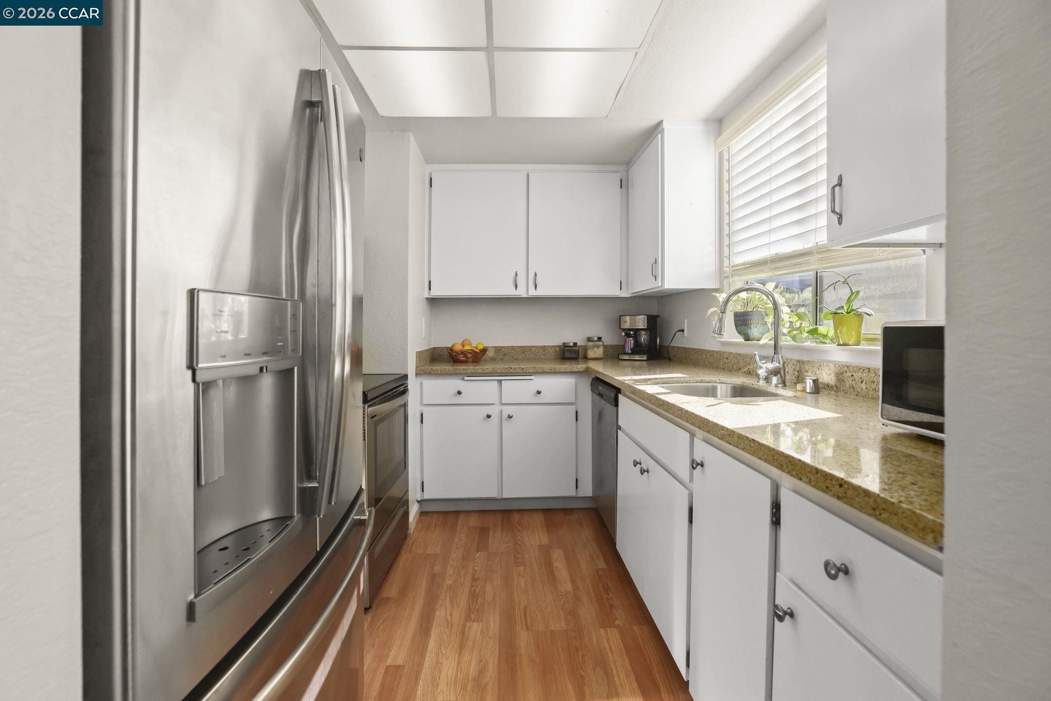 641 Chadwick Lane Bay Point, CA 94565 - Photo 7 of 20 a kitchen with granite countertop white cabinets and white appliances