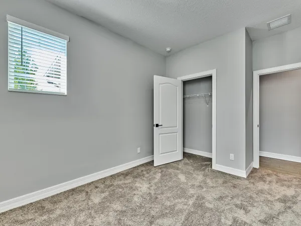 a large kitchen with stainless steel appliances granite countertop a stove a sink and white cabinets with wooden floor