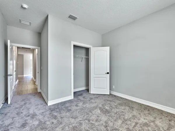 a kitchen with a sink stainless steel appliances and white cabinets