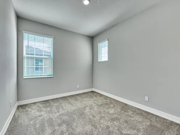 a bedroom with a bed and a table with a potted plant
