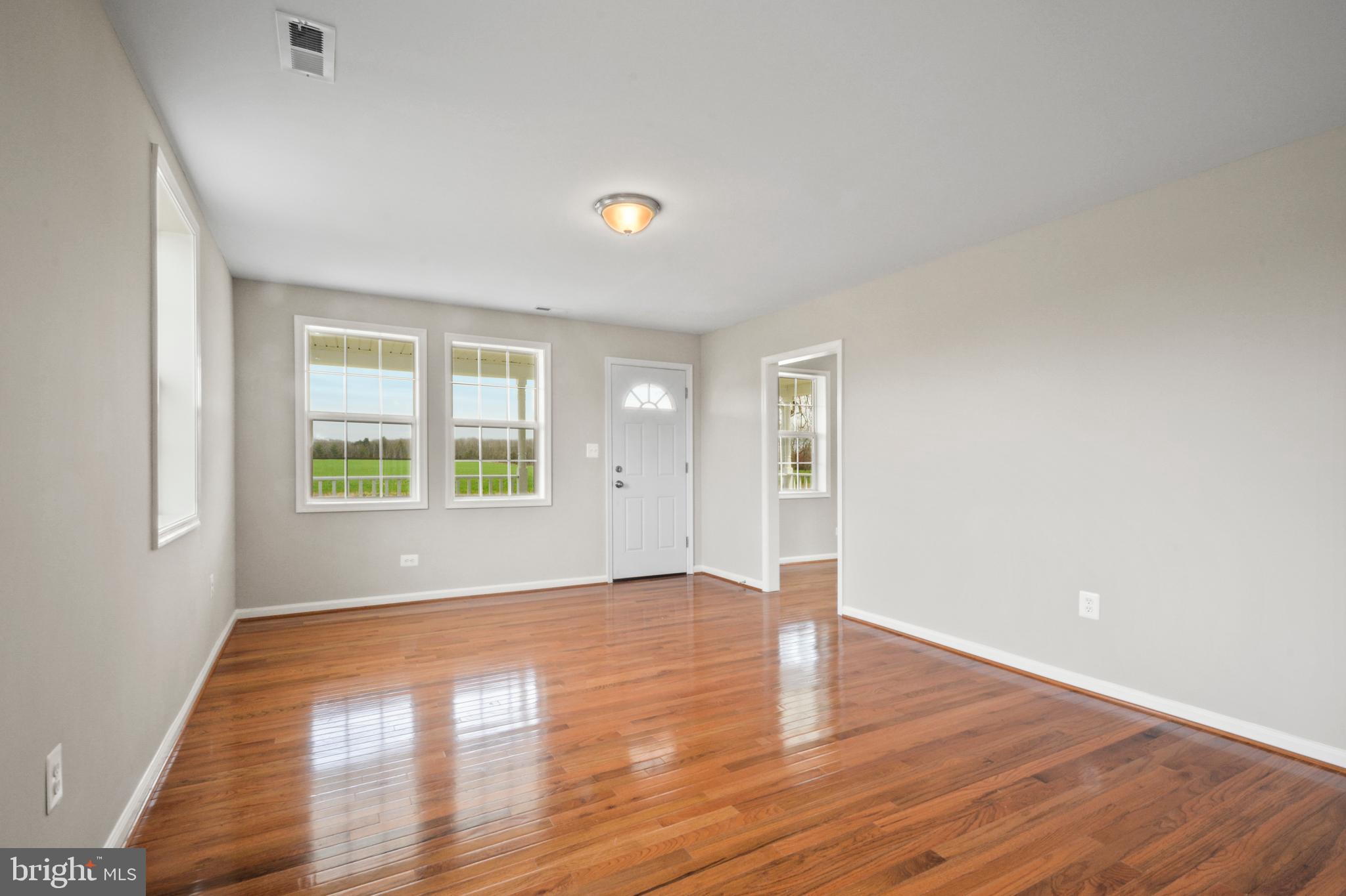 2986 Partlow Road Partlow, VA 22534 - Photo 8 of 36 an empty room with wooden floor and windows