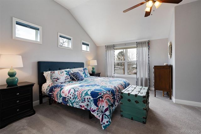 a bed sitting in a bedroom next to a window with a chandelier