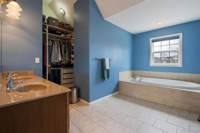 a bathroom with a bathtub and a window