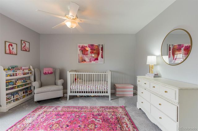 a bedroom with furniture and a baby crib