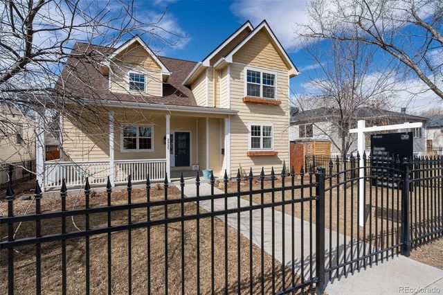 a view of a brick house with wooden fence
