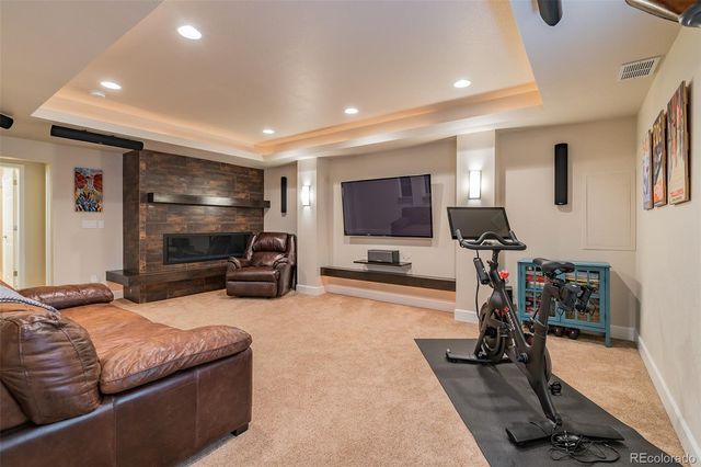 a living room with furniture gym equipment and a flat screen tv