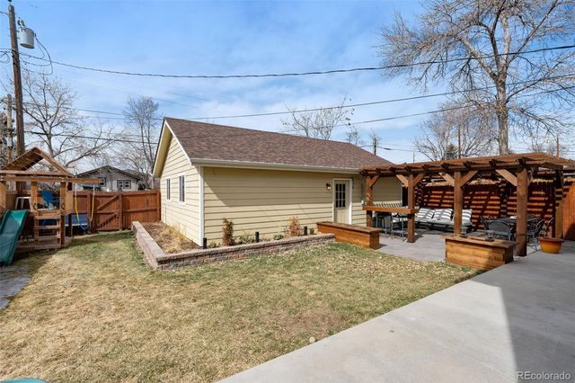 a backyard of a house with barbeque oven table and chairs