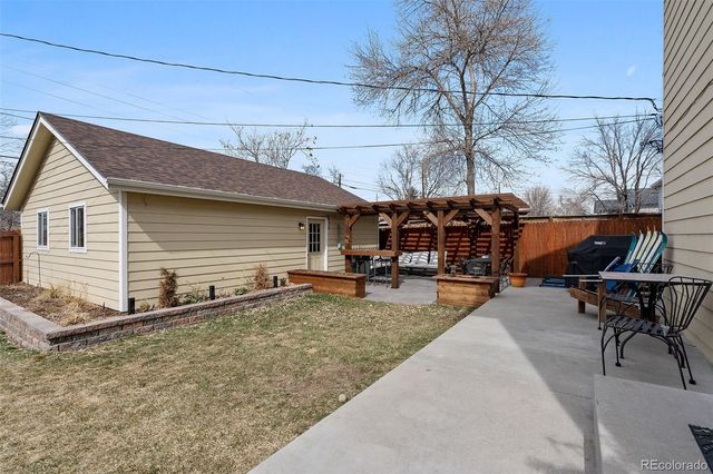 a view of a patio with table and chairs