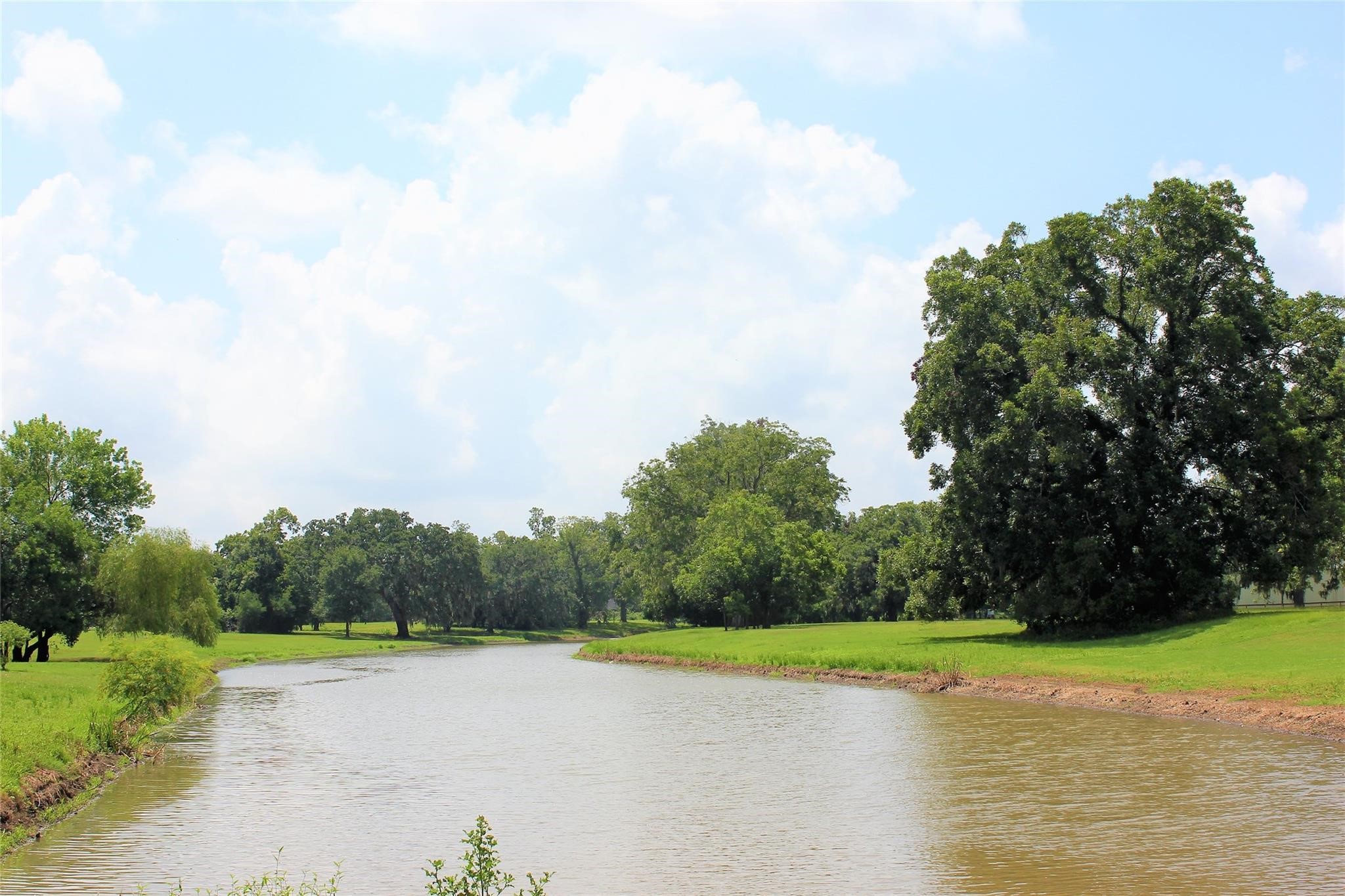 248 Middle Bayou Trail Angleton, TX 77515 - Photo 17 of 18 a view of a lake and trees in the background