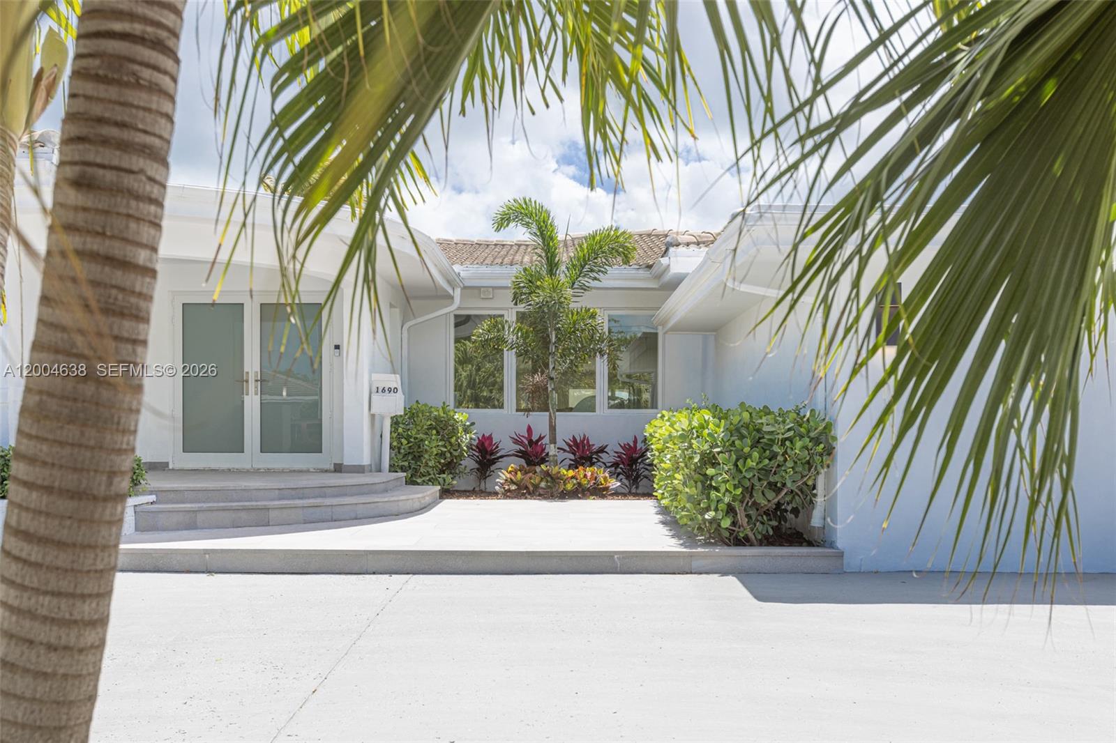 1690 Daytonia Road Miami Beach, FL 33141 - Photo 88 of 88 a front view of a house with a garden