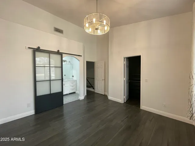 an empty room with wooden floor and window