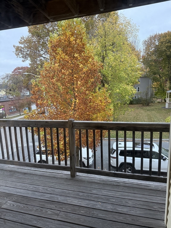 a view of balcony with wooden floor