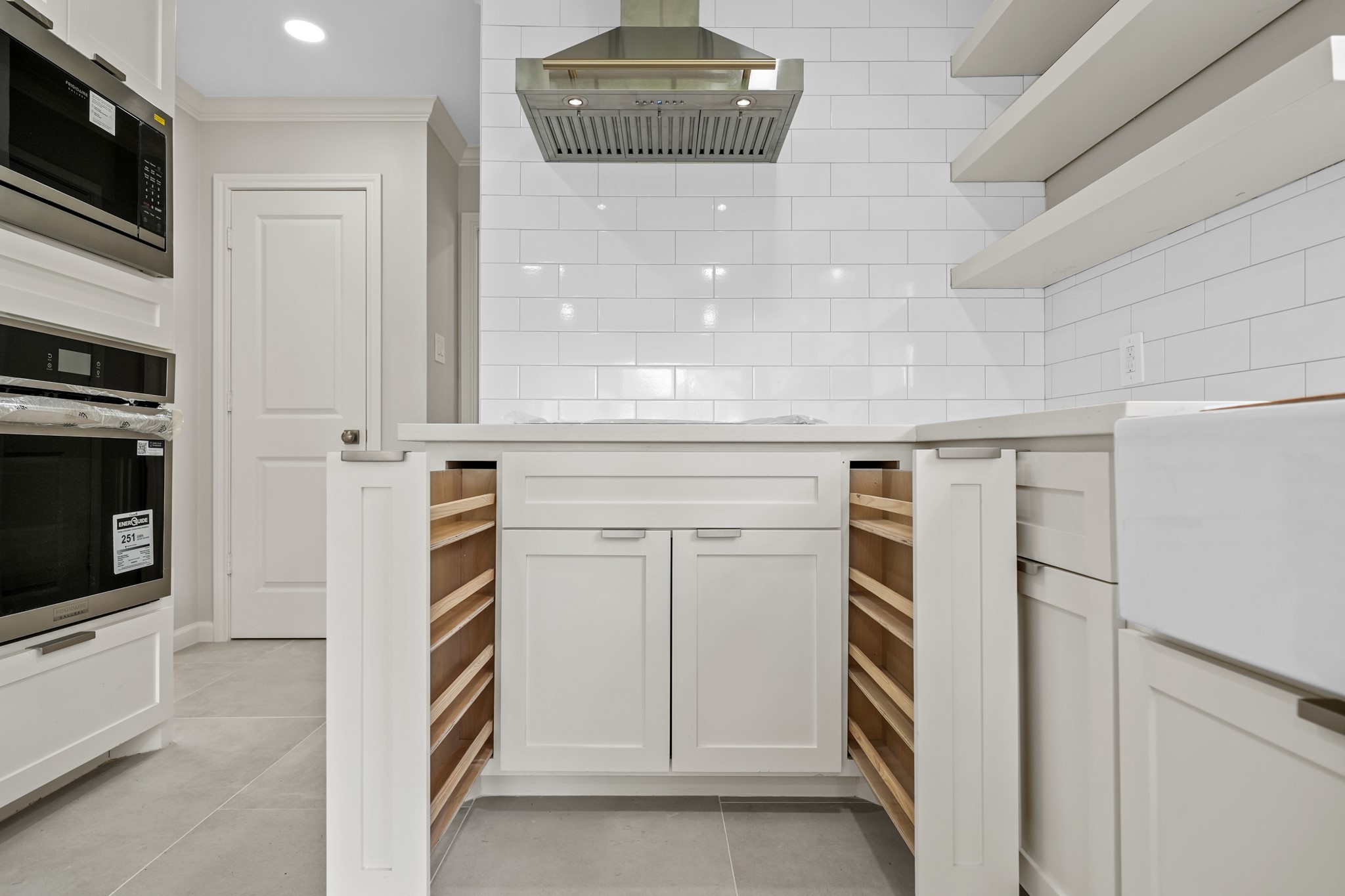 2261 Riverside Drive West Columbia, TX 77486 - Photo 17 of 44 Flat surface range and vent hood with side pull out spice racks...nothing was missed in this kitchen design!