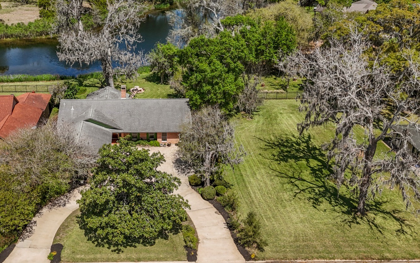 2261 Riverside Drive West Columbia, TX 77486 - Photo 2 of 44 Originally designed by a Houston hotelier for effortless one-story living, the thoughtfully planned layout blends comfort, function, and scenery throughout.