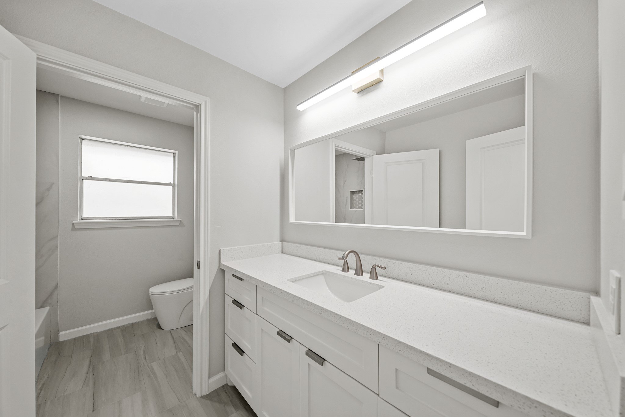 2261 Riverside Drive West Columbia, TX 77486 - Photo 31 of 44 Hall bath offers quartz counters, custom solid wood separate vanity area from the tub/shower combo. There is a full cedar closet in the hall way off of this bathroom.