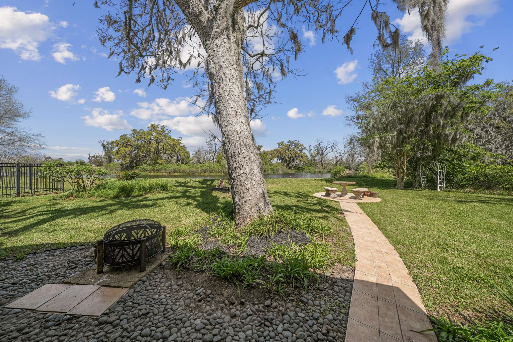 2261 Riverside Drive West Columbia, TX 77486 - Photo 34 of 44 Enjoy the extended covered patio beneath magnolia and crepe myrtles, with fox goldenrod, spanish moss covered trees, fig trees and more!
