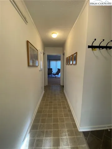 a view of a hallway with a refrigerator