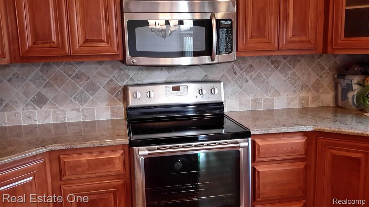8625 35 Mile Road Romeo, MI 48065 - Photo 6 of 46 Stove/oven/microwave with granite counters