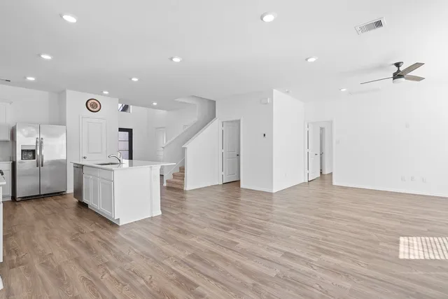 a view of a kitchen with a sink and a refrigerator