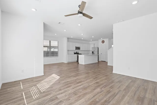 a view of kitchen and hall with wooden floor