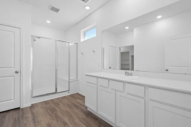 a bathroom with a double vanity sink and mirror