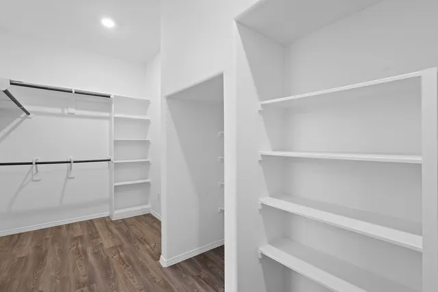 a view of walk in closet with empty racks