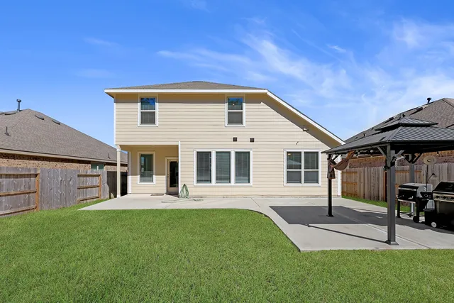 a front view of a house with garden and sitting area