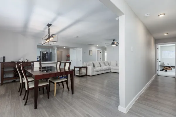 a view of a dining room with furniture and wooden floor