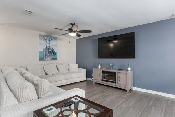a living room with furniture and kitchen view