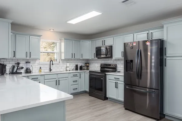 a kitchen with a refrigerator and a sink