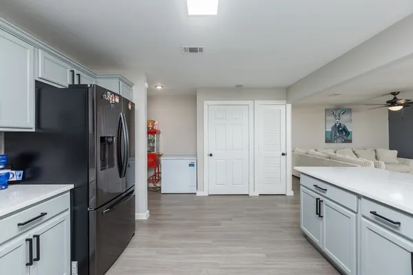 a kitchen with a sink and wooden floor