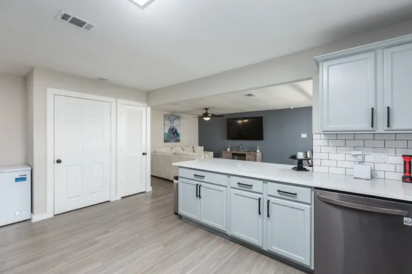 a bathroom with a sink vanity mirror and toilet