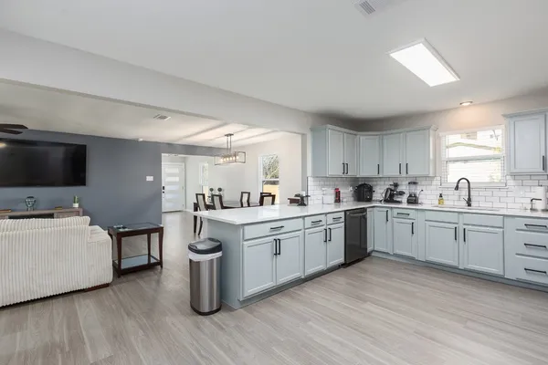 a spacious bedroom with a bed and a flat screen tv