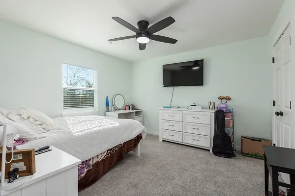 a bathroom with a toilet sink and shower curtain