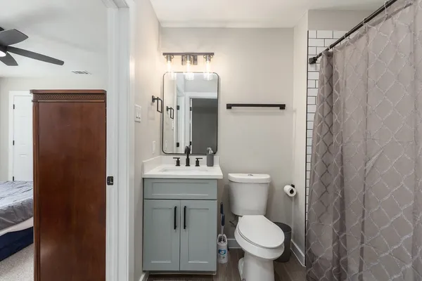 a bedroom with bed and a chandelier